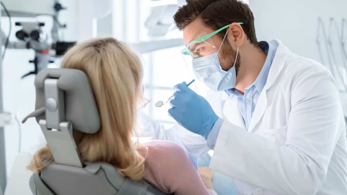 Patient receiving professional teeth whitening with a laser device Burnley
